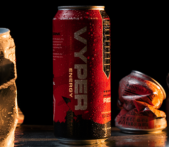 black and red vyper energy can standing tall amongst crushed cans of competitors
