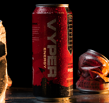 black and red vyper energy can standing tall amongst crushed cans of competitors